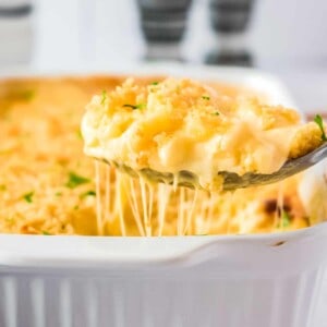 Mac and Cheese auf einem großen Löffel mit Käsefäden