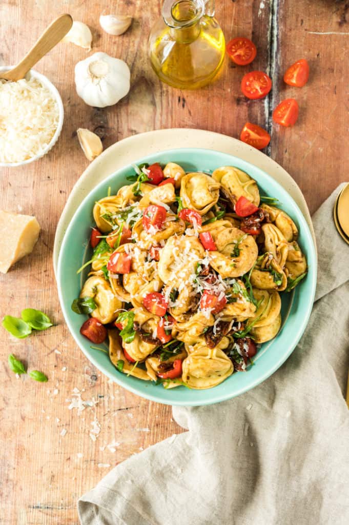 Tortellini-Salat in türkisfarbener Schale von oben