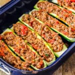 gefüllte Zucchini in blauer Ofenform vor dem Backen