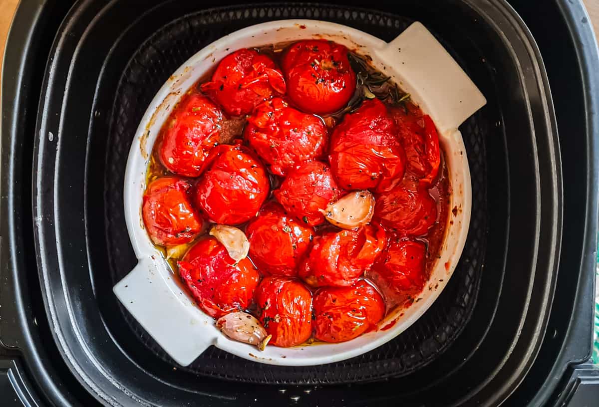 Gebackene Tomaten in weißer Form im Korb der Heißluftfritteuse